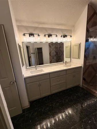 a bathroom with a sink and mirror