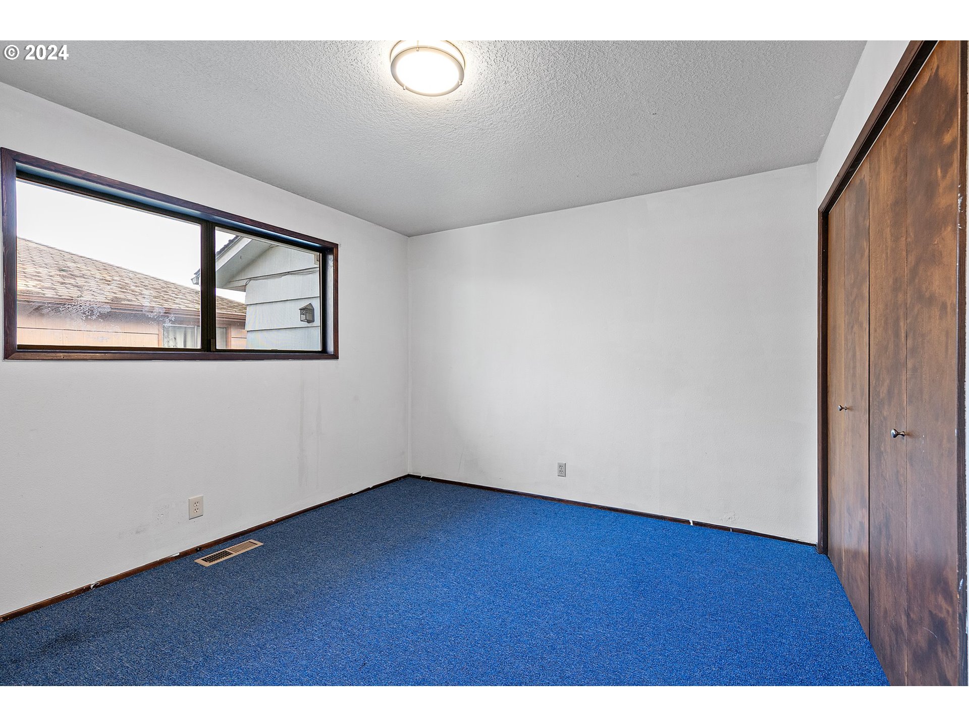 4091 Bell Avenue Eugene, OR 97402 - Photo 11 of 29 an empty room with wooden floor and windows