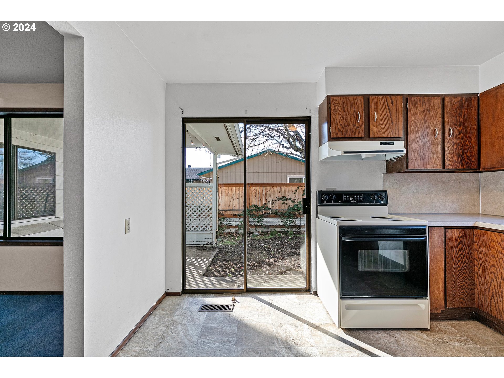 4091 Bell Avenue Eugene, OR 97402 - Photo 7 of 29 a kitchen with stainless steel appliances granite countertop a stove a refrigerator and a sink with wooden cabinets