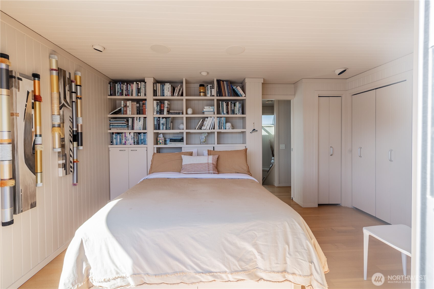 2017 Fairview Avenue East, Unit I Seattle, WA 98102 - Photo 24 of 34 a bedroom with a large bed and a book shelf