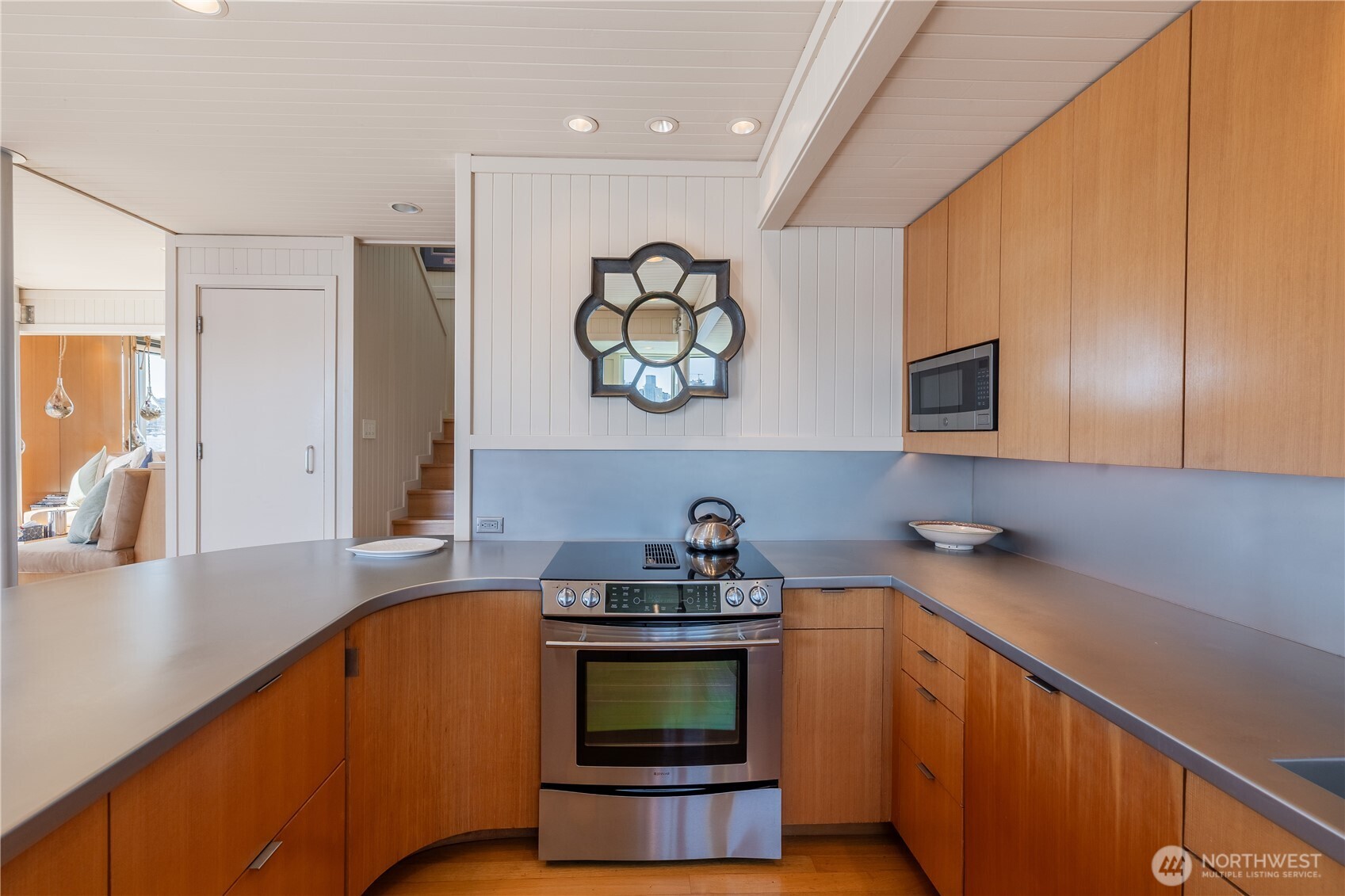 2017 Fairview Avenue East, Unit I Seattle, WA 98102 - Photo 10 of 34 a kitchen with stainless steel appliances granite countertop a sink a stove cabinets and wooden floor