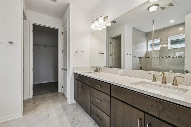 a bathroom with a double vanity sink and a mirror