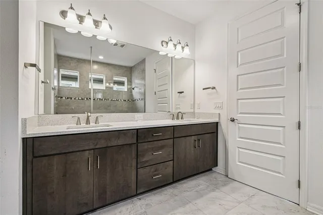 a bathroom with a double vanity sink mirror and