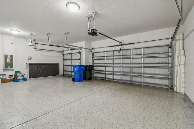 an aerial view of residential houses with outdoor space and lake view