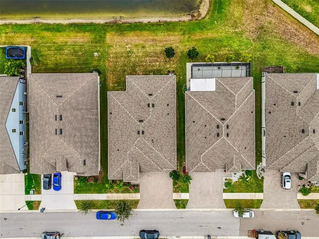 an aerial view of residential houses with outdoor space