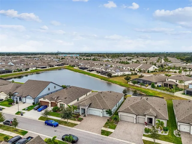 an aerial view of a house with a swimming pool yard and outdoor seating