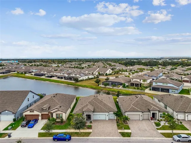 an aerial view of a house with a swimming pool outdoor seating and yard