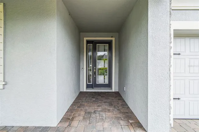 a view of a hallway with a white walls and a window