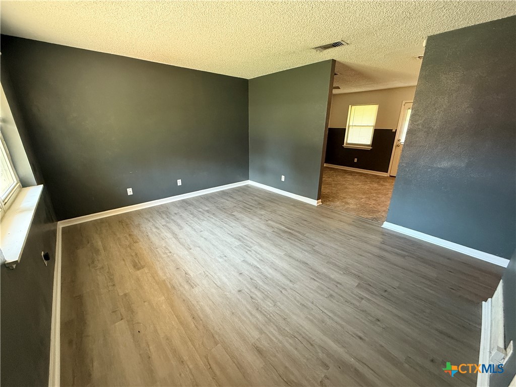 809 Michelle Drive Copperas Cove, TX 76522 - Photo 2 of 12 an empty room with wooden floor and windows
