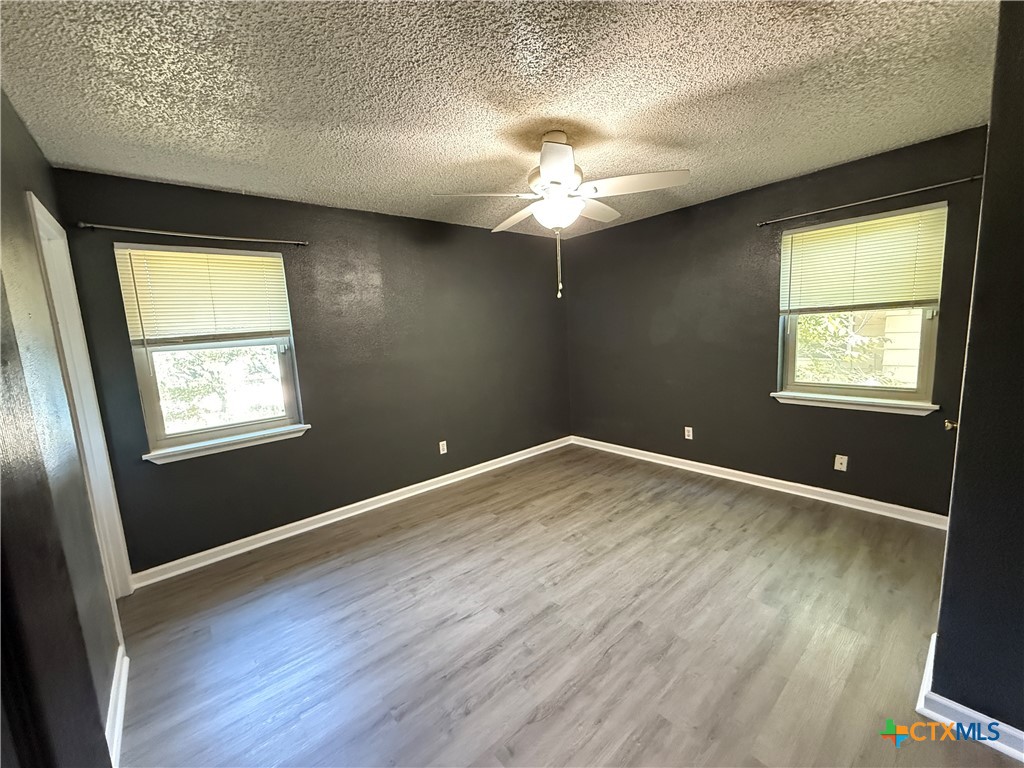809 Michelle Drive Copperas Cove, TX 76522 - Photo 7 of 12 a view of an empty room with a window and wooden floor