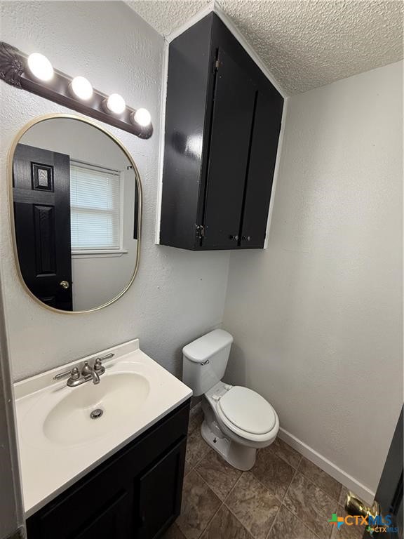 809 Michelle Drive Copperas Cove, TX 76522 - Photo 8 of 12 a bathroom with a toilet sink and mirror