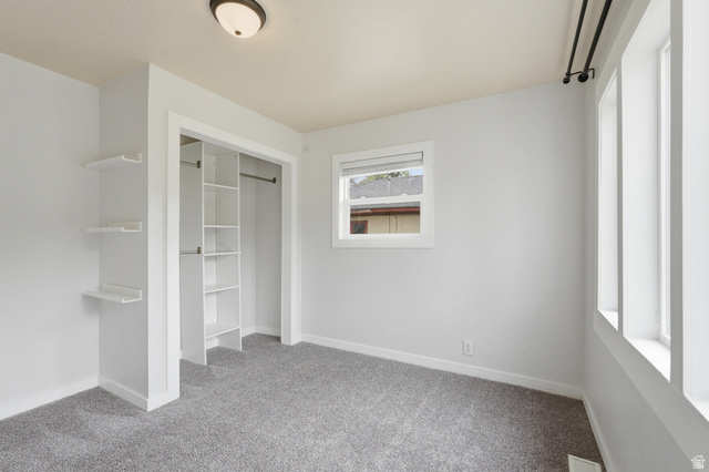 215 East 300 South Logan, UT 84321 - Photo 16 of 32 Unfurnished bedroom featuring a closet and light colored carpet