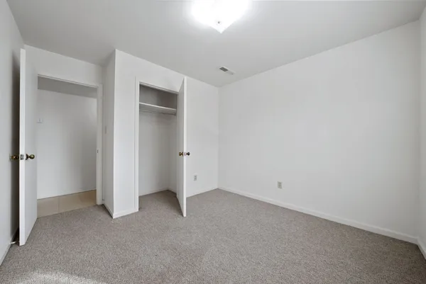 an empty room with closet area