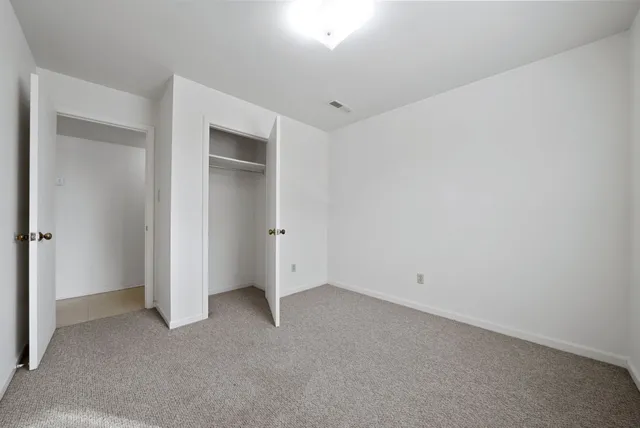 an empty room with closet area