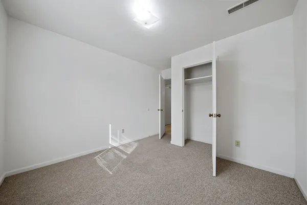an empty room with closet area