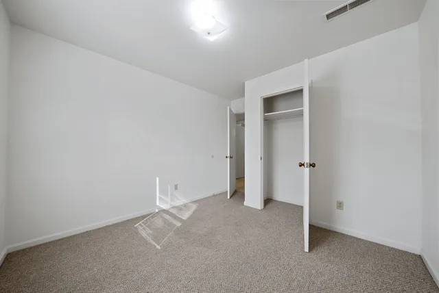an empty room with closet area