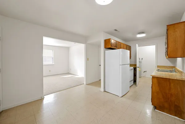 a view of a kitchen with a refrigerator a microwave and a sink
