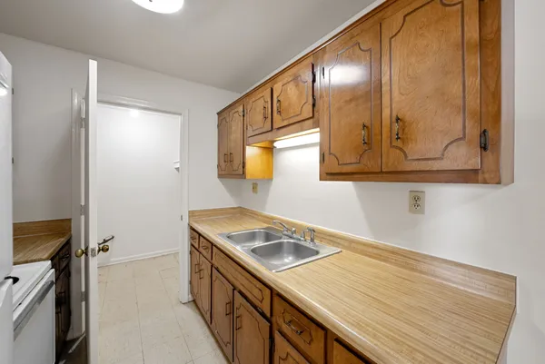 a kitchen with a sink stove and microwave