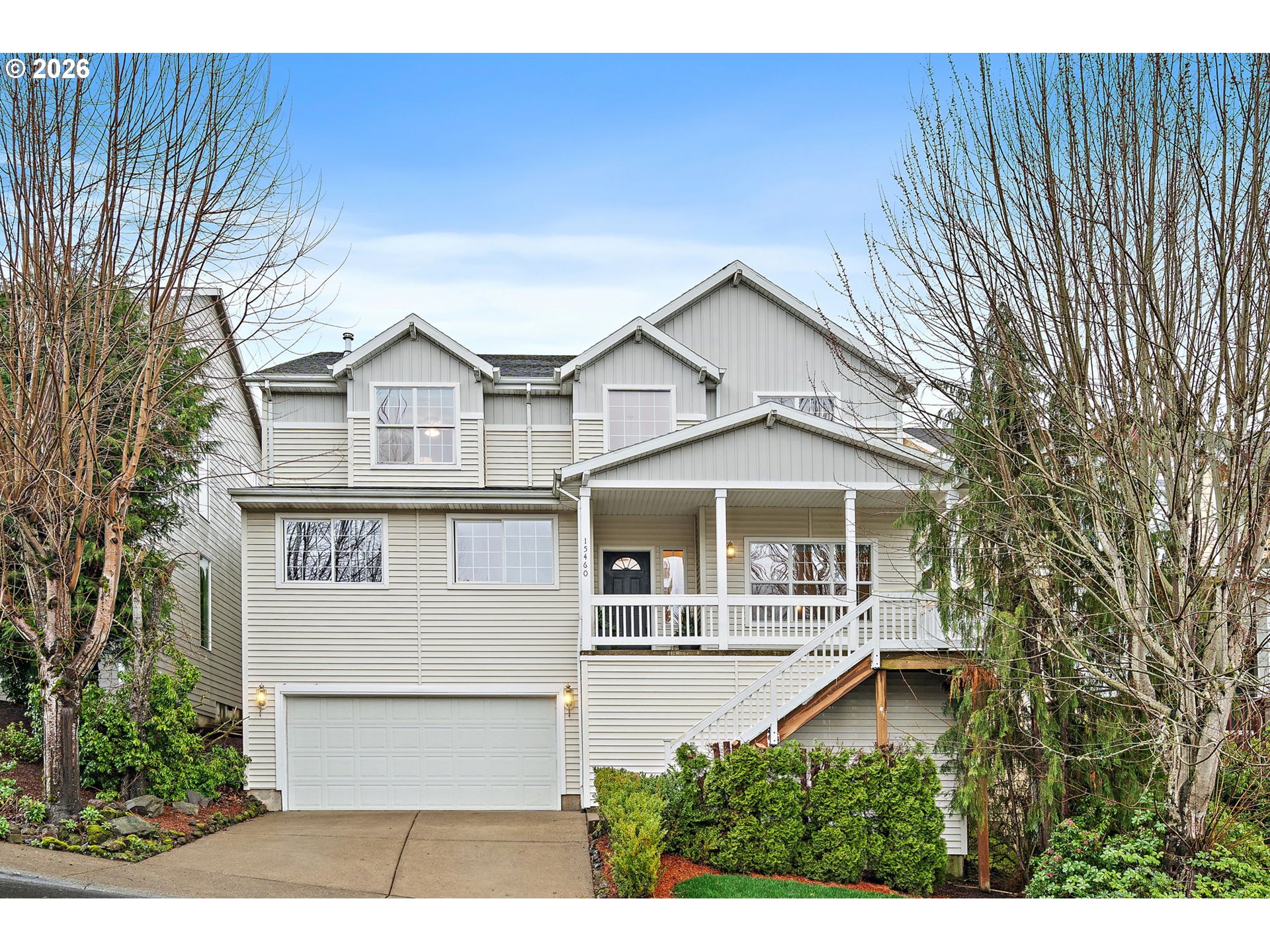 a front view of a house with a yard garage and outdoor seating