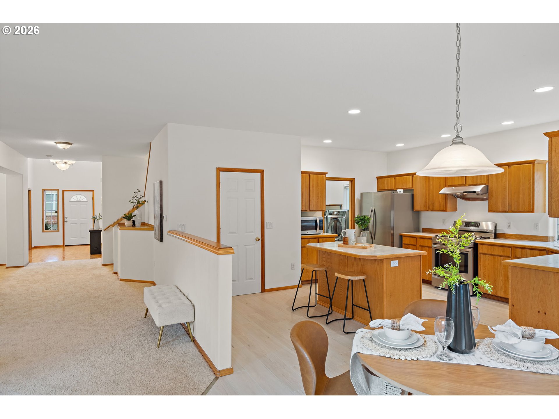 15460 Southwest 145th Terrace Tigard, OR 97224 - Photo 20 of 45 a living room with furniture a wooden floor and kitchen view