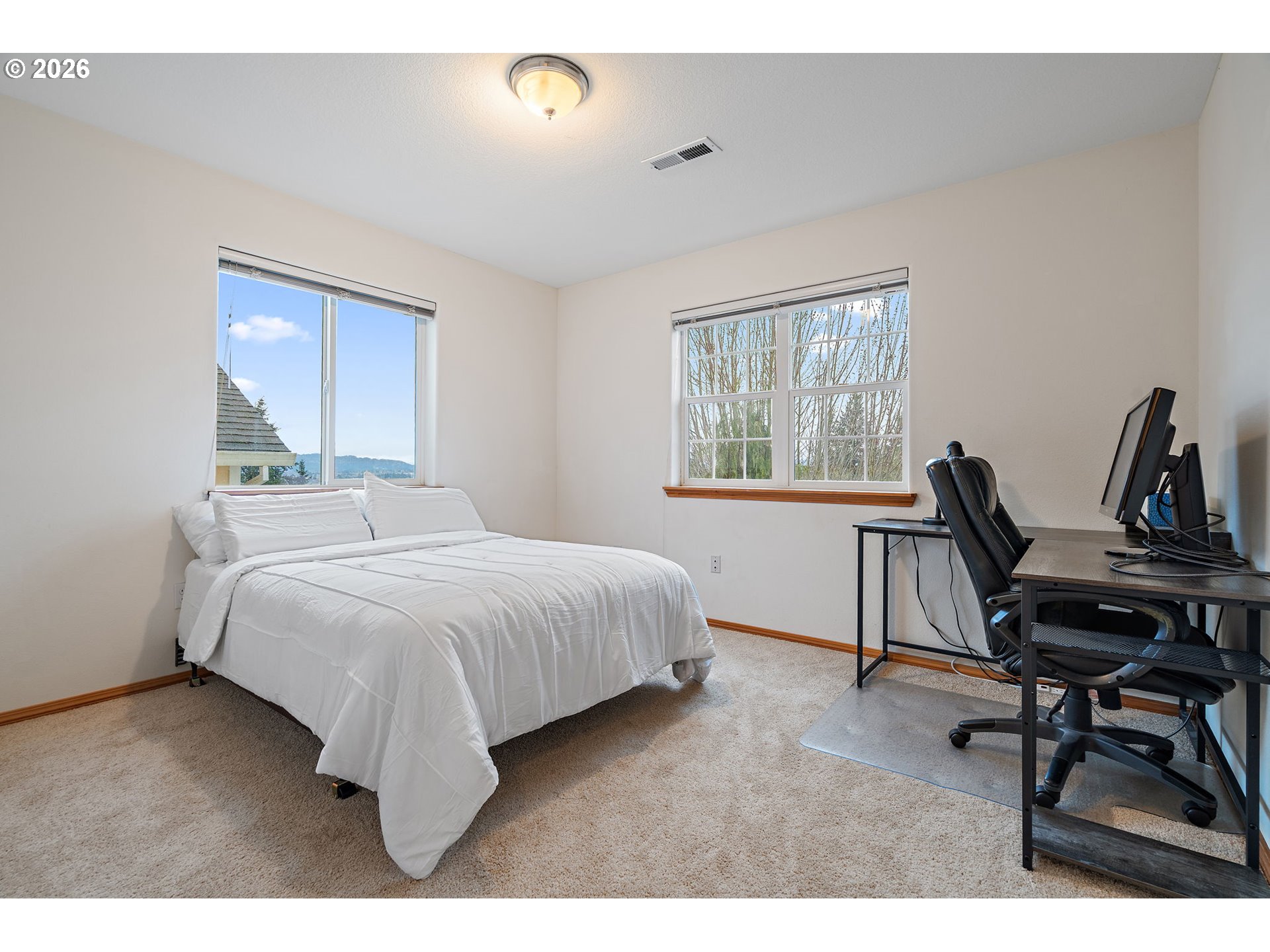 15460 Southwest 145th Terrace Tigard, OR 97224 - Photo 43 of 45 a bedroom with a bed a desk and chair with wooden floor