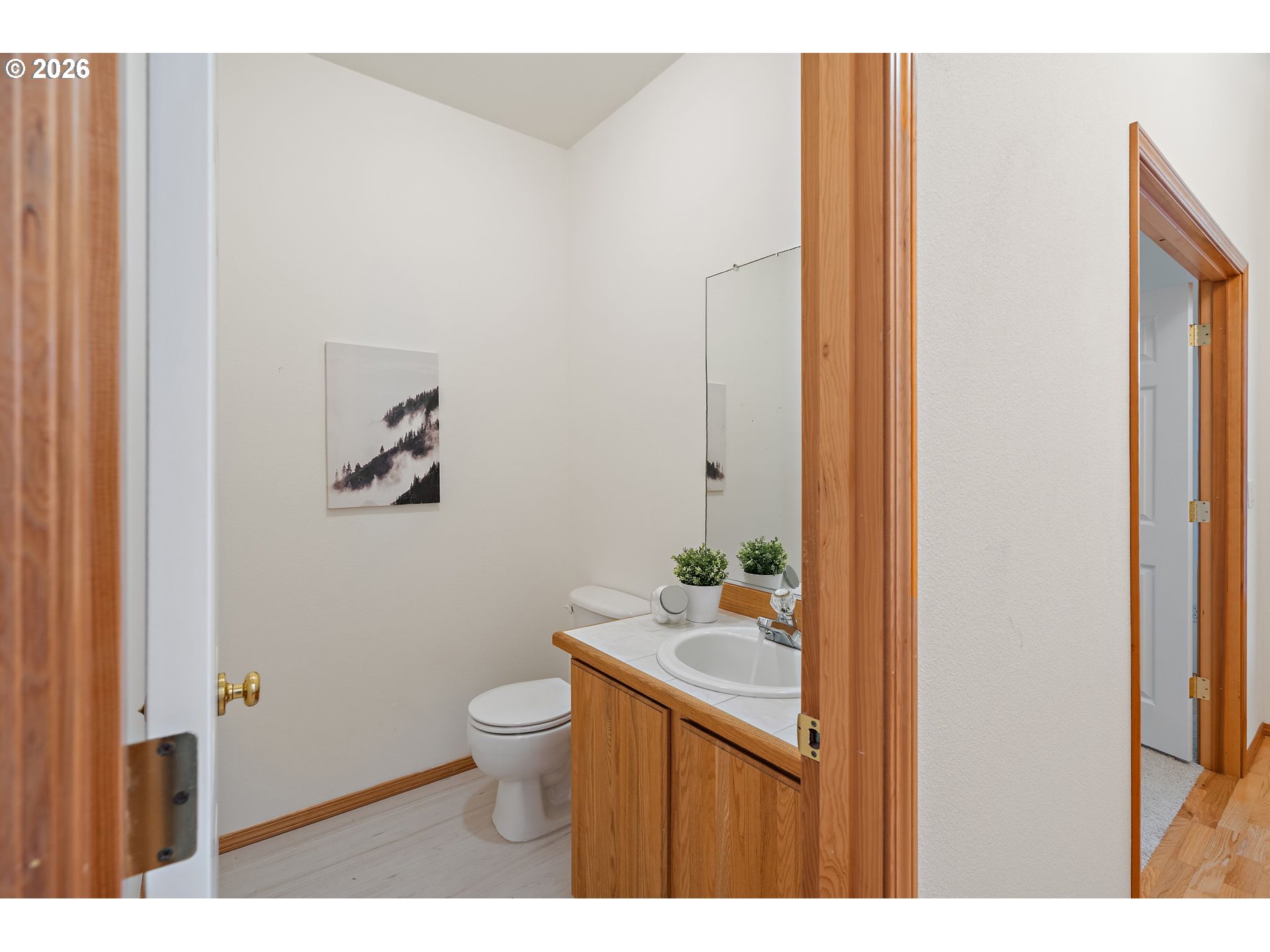 15460 Southwest 145th Terrace Tigard, OR 97224 - Photo 7 of 45 a bathroom with a granite countertop sink a toilet and a mirror