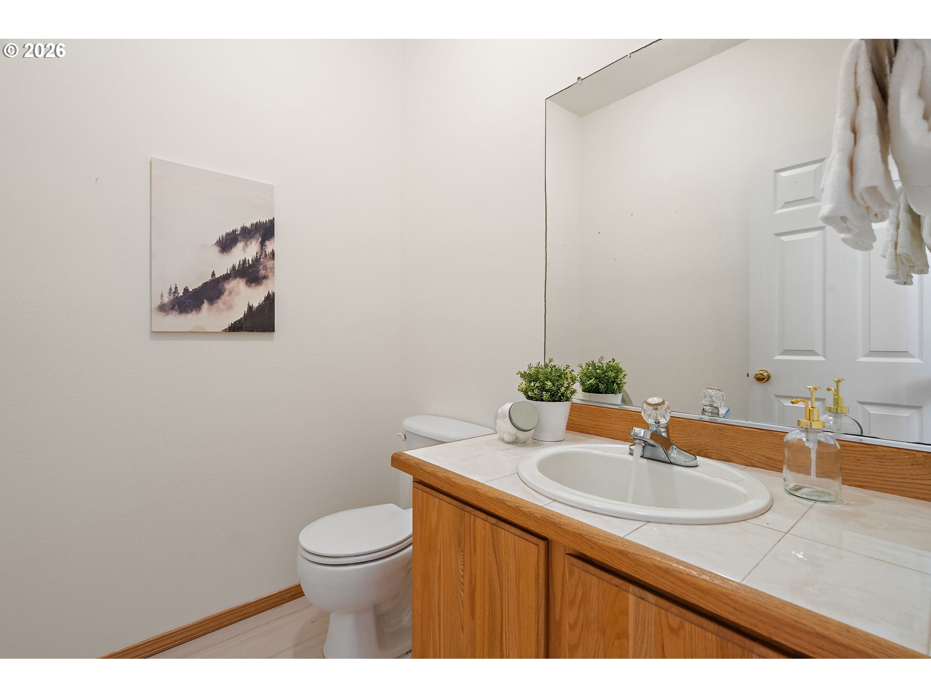 15460 Southwest 145th Terrace Tigard, OR 97224 - Photo 8 of 45 a bathroom with a sink a toilet and a mirror