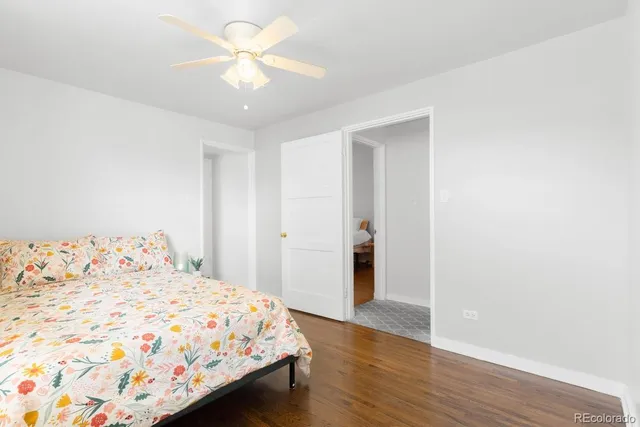 a bedroom with a bed and a chandelier fan