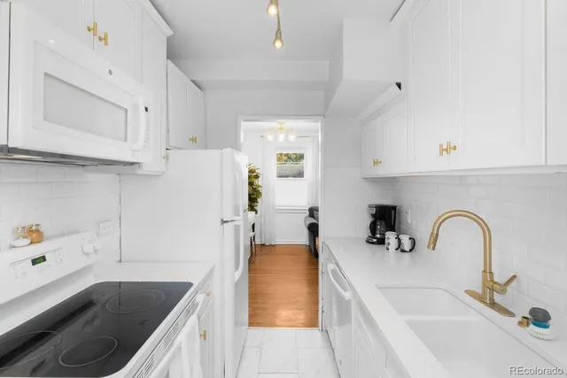 a kitchen with a sink a stove and cabinets
