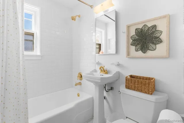 a bathroom with a toilet and a bathtub