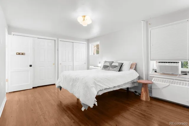 a spacious bedroom with a bed and a window