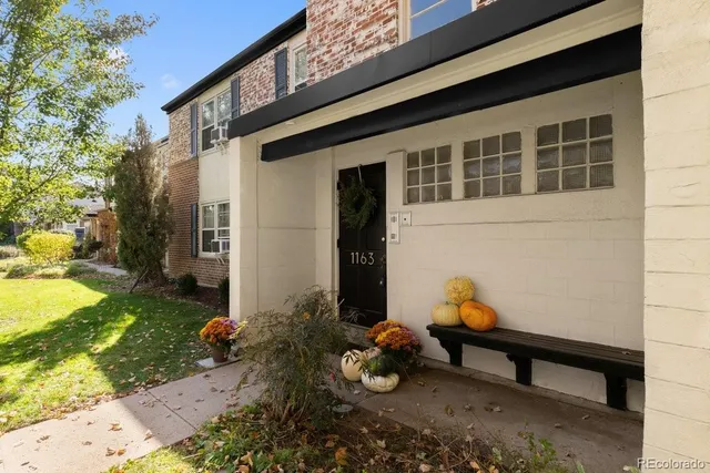a backyard of a house with outdoor seating