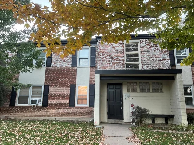 front view of a house with a tree