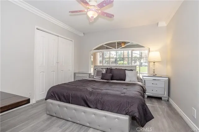 a bedroom with a large bed and a chandelier