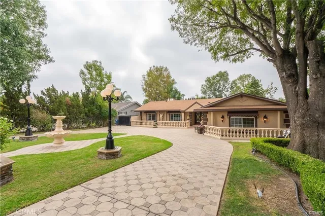 a front view of a house with a garden