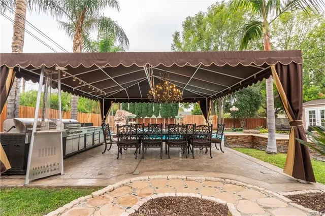 a couple of chairs sitting in patio with a yard