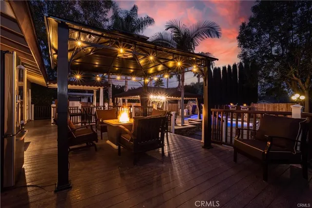 a view of a patio with dining table and chairs with wooden floor