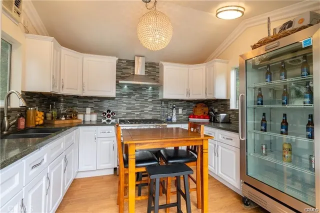 a kitchen with table chairs cabinets and stainless steel appliances