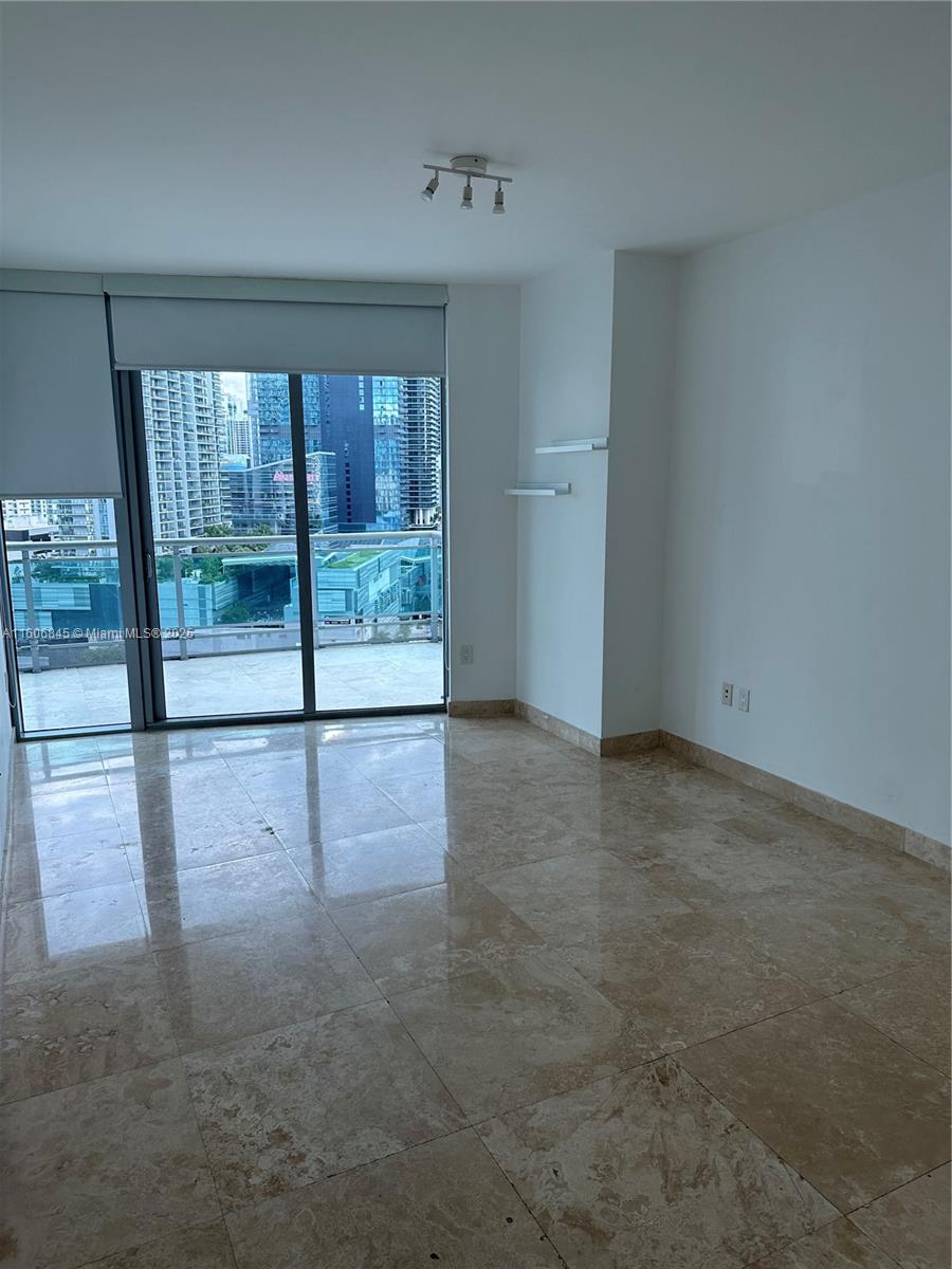 350 South Miami Avenue, Unit 2302 Miami, FL 33130 - Photo 9 of 32 an empty room with sliding glass door and outer view