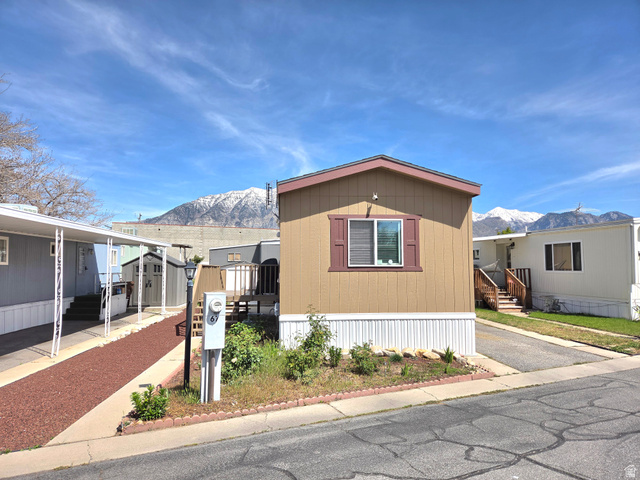 597 North State Street, Unit 67 Orem, UT 84057 - Photo 2 of 23 Manufactured / mobile home featuring a mountain view and a storage unit
