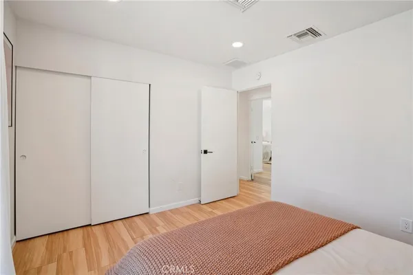 a bedroom with a bed and a walk in closet