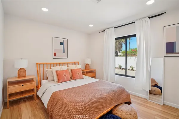 a bedroom with a bed and wooden floor