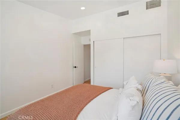 a bedroom with a bed and a lamp