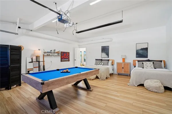 a bedroom with furniture and a wooden floor