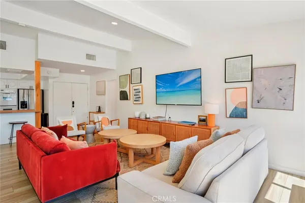 a living room with furniture a couch and a flat screen tv