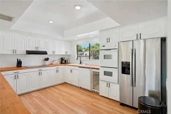 a kitchen with stainless steel appliances a refrigerator sink and cabinets