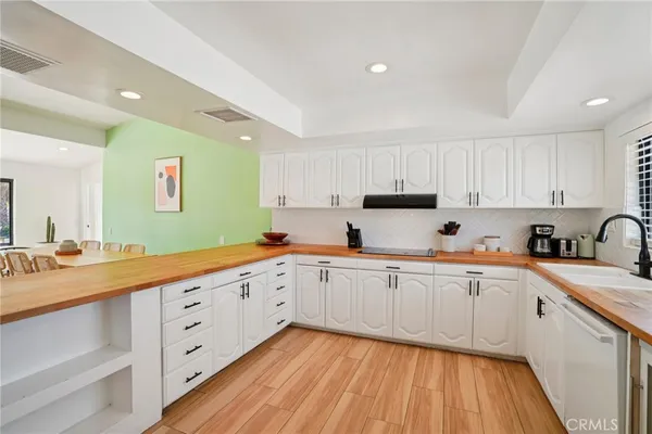 a kitchen with sink cabinets and wooden floor