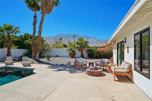 a view of a patio with couches and potted plants