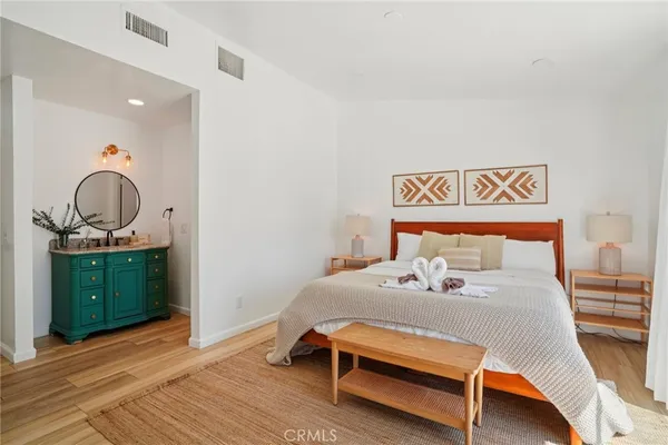 a bedroom with a bed and cabinets