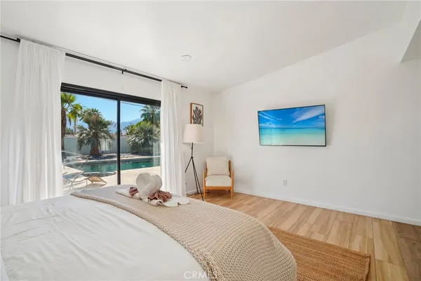 a bedroom with a bed and a large window
